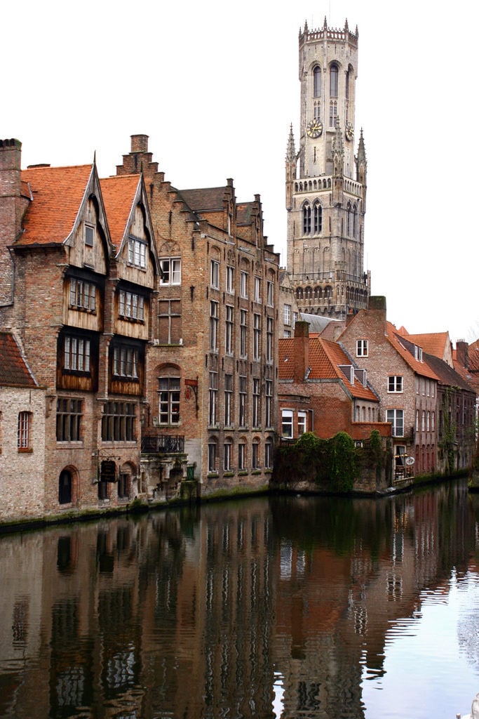 View of the top of bell tower as seen from a canal