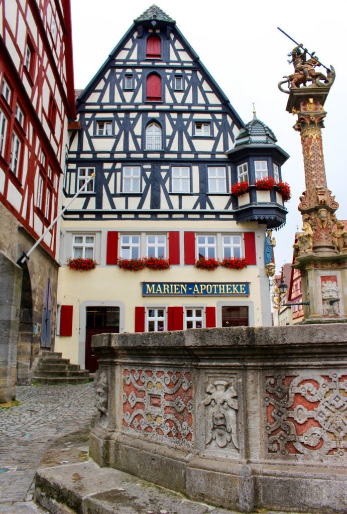 Beautiful medieval building by a tall monument