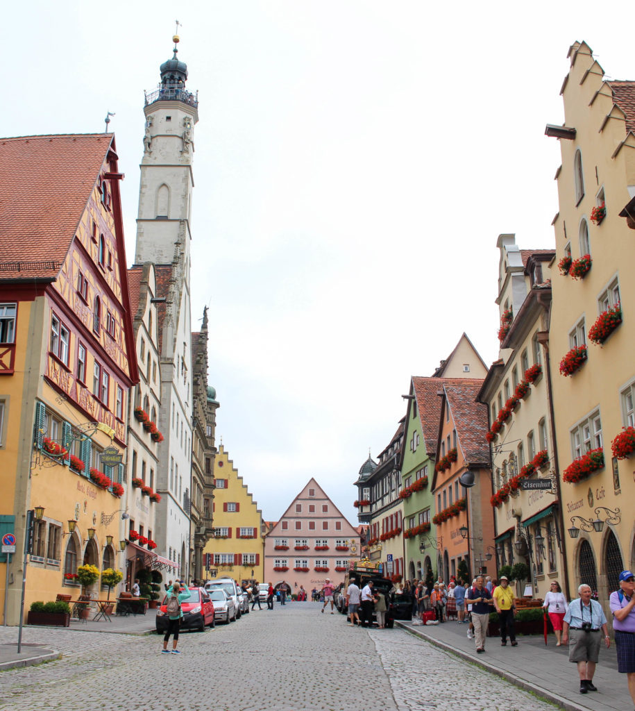 Tourists walking and taking pictures in Rothenburg ob der Tauber - Germany's fairy-tale dream town