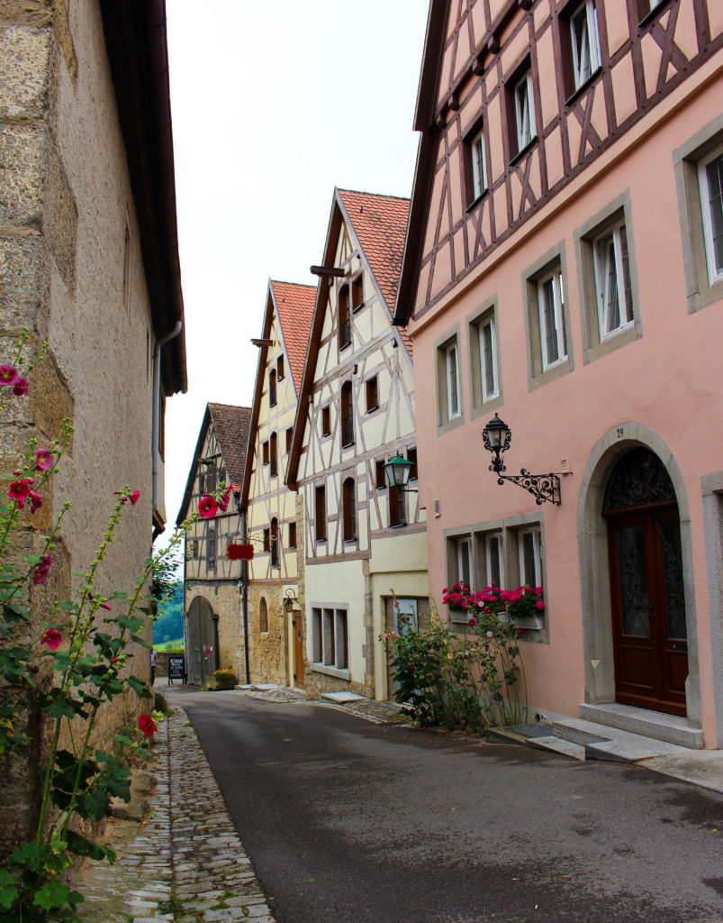 A quiet street in Altstadt with houses decorated with flowering plants