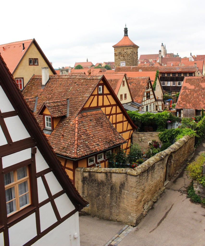 Old houses with high stone fences and worn-out roof tiles