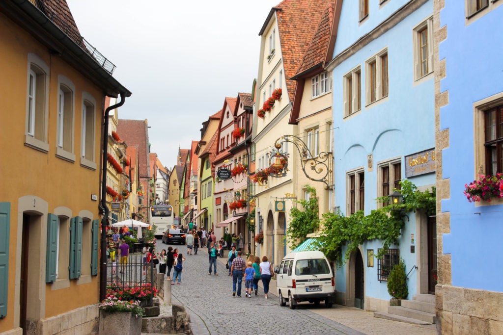 Tourists walking along the cobblestone streets during their visit to Rothenburg ob der Tauber, Germany