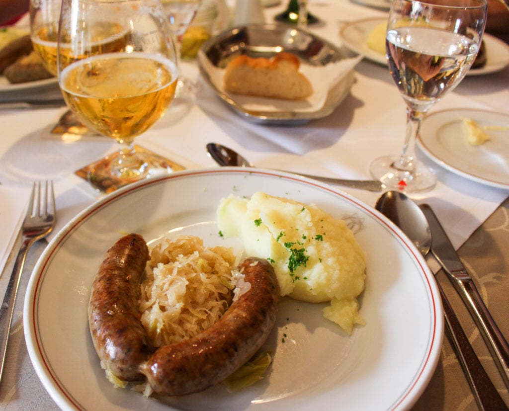 Sausages, sauerkraut, and mashed potatoes served on a plate