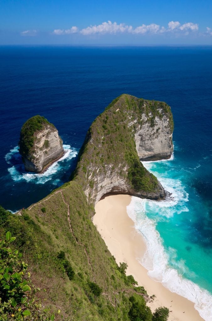 Sandy beach and lush island surrounded by deep blue waters