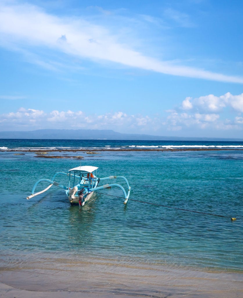 A boat docked on the beach during our East Bali day trip