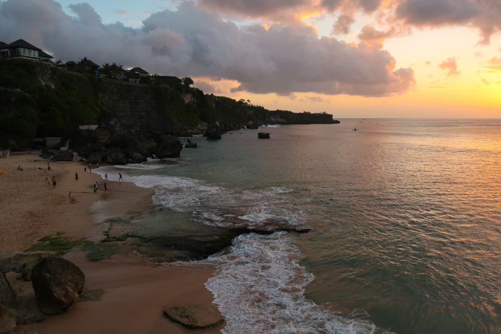 Sunset by the beach in Uluwatu - one of the best places to explore during your three weeks in Bali
