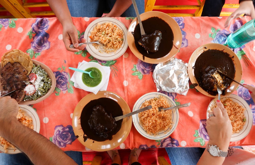 Eating different kinds of Mexican dishes on a Xochimilco boat