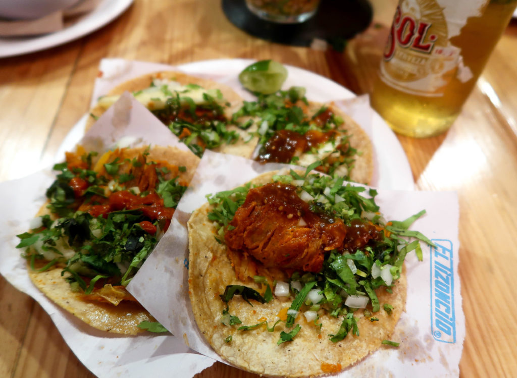 Tacos al pastor served on a plate. In this Mexico City foodie guide, we recommend trying out the tacos al pastor from El Tizoncito.