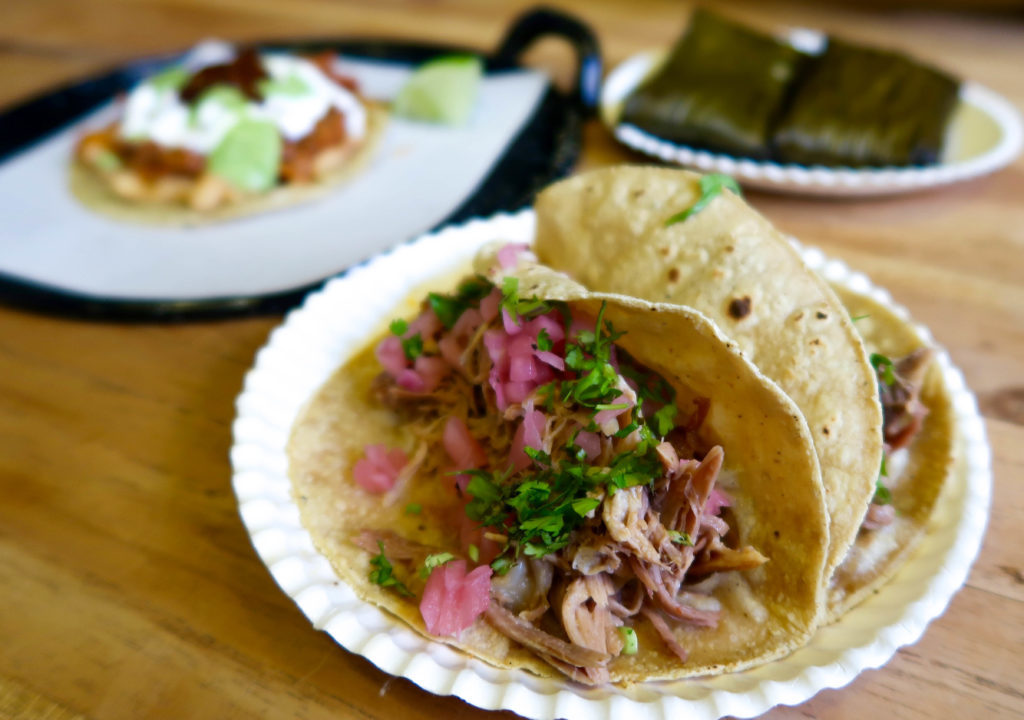 Delicious tacos on paper plates. This Mexico City foodie guide won't be complete without the Mercado Roma food stands.