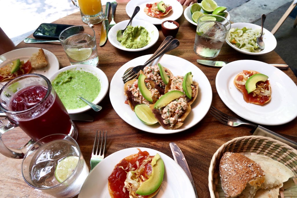 Plates of tuna tostadas and side dishes at Contramar - one of the best Mexico City restaurants for foodies