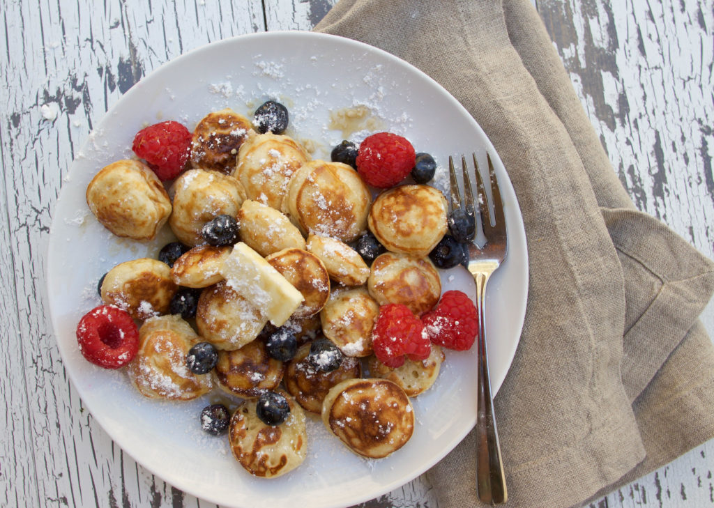 If you're looking for an authentic poffertjes recipe, then look no further! Poffertjes, also known as mini Dutch pancakes, are the perfect sweet treat, for breakfast or a late-night snack. This mini pancakes recipe yields the cutest, fluffiest little pancakes, and you are going to love them! Serve them the traditional way with some butter and powdered sugar, or add other toppings like syrup, berries, whipped cream, or even ice cream! Yummy!