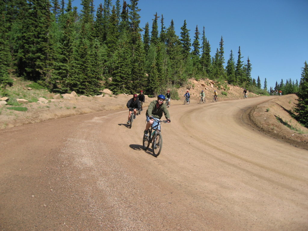 People going down the trails at Pikes Peak by bicycles