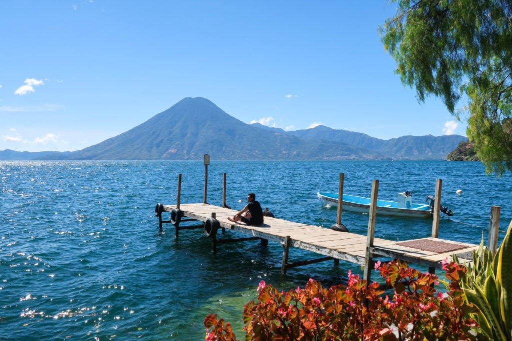 Dock at Lake Atitlan with volcano in the background. This lake is one of the best reasons to visit Guatemala.