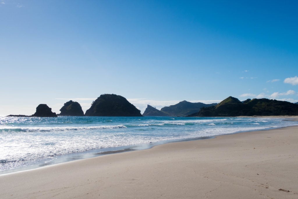 Rocky mountain formations near a beach in Great Barrier Island