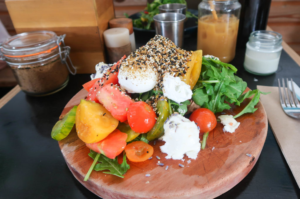 Delicious plate of the Dukkah Poached Eggs breakfast. One of the best things to do in Byron Bay is to go to its local cafés and try out their food.
