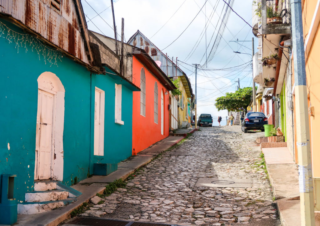 Cobblestone street in Flores, Guatemala surrounded by colorful houses