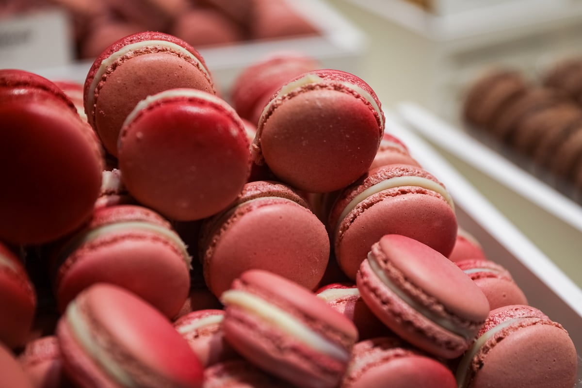 A box of pink macarons on display at a bakery in Paris