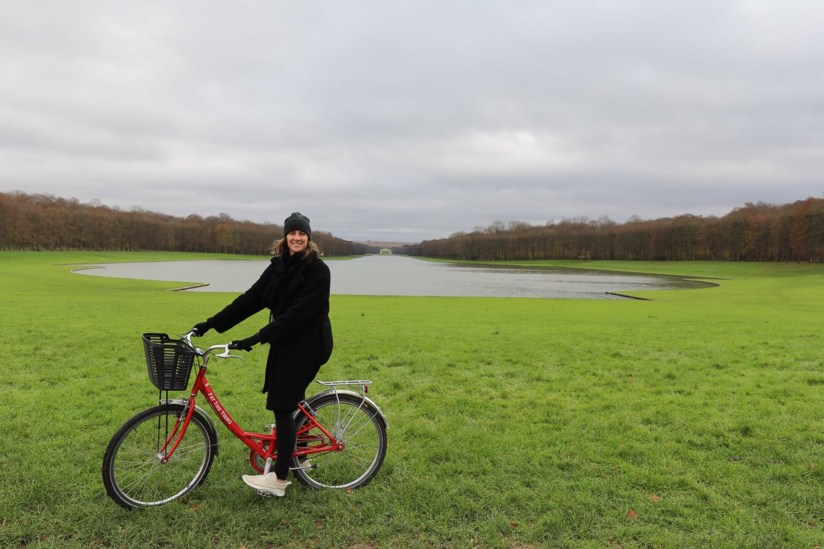 Maddy on her bike in front of the Grand Canal of Versailles on a day trip from Paris