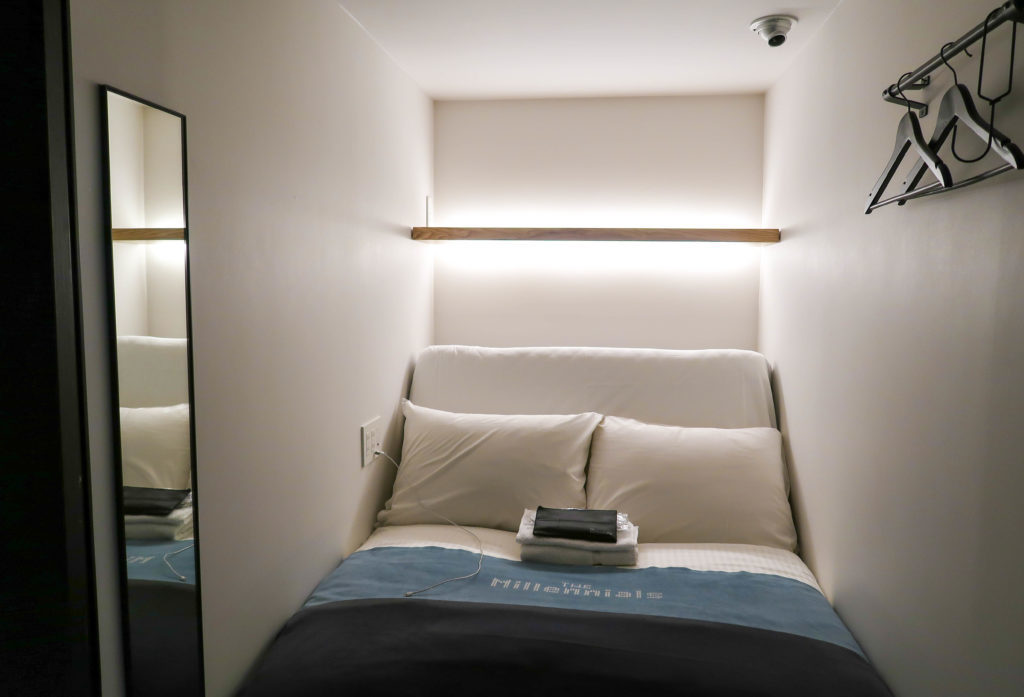 A narrow, minimalist hotel bed. If you're wondering where to stay during your two days in Kyoto, I highly recommend The Millennials hotel.