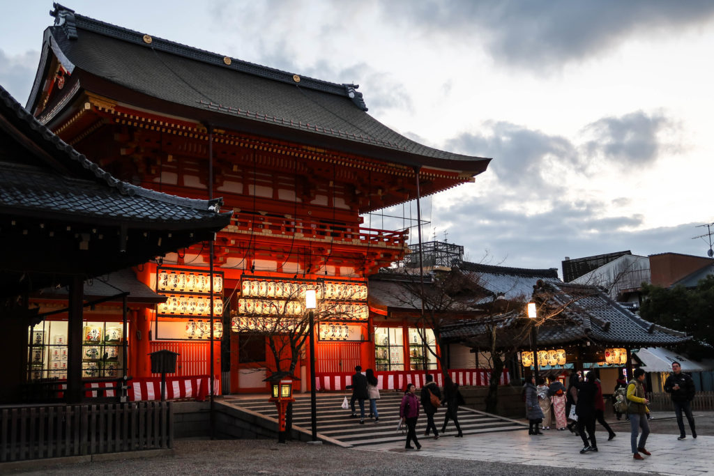 People heading towards a Japanese temple at dusk