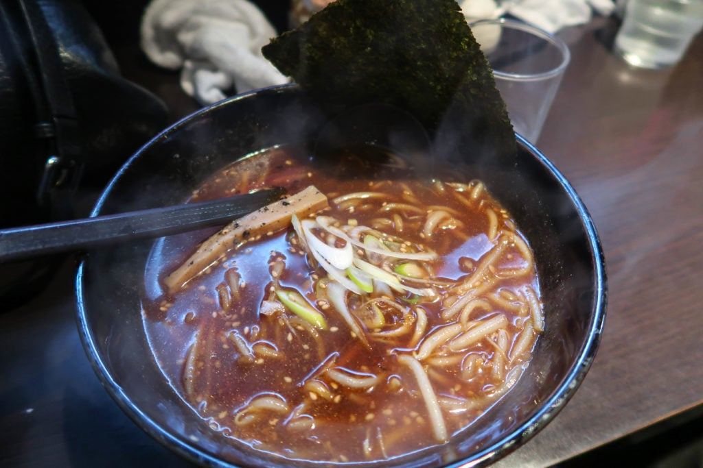 Steaming bowl of ramen at Ramen Toguchi. If you're wondering where to eat in Sapporo, this tiny ramen shop is a good choice.