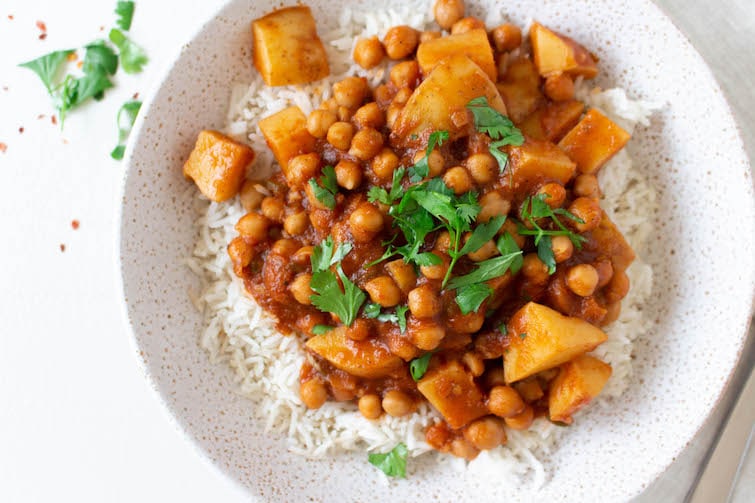 Vegan chana aloo masala, also known as Indian chickpea and potato curry, is delicious and nutritious. Packed with spices, herbs, and vegetables, and served over basmati rice, you will love this plant-based meal.