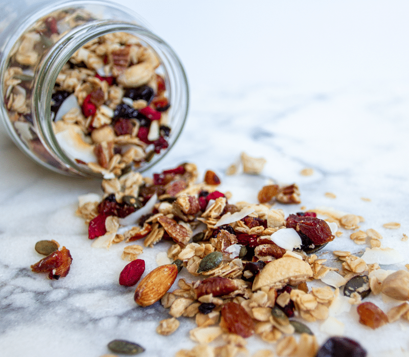 Granola stored in a jar. This is the best homemade granola recipe. It's healthy and easy, and loaded with oats, nuts, seeds, fruit, and coated in maple, vanilla, cinnamon, and coconut oil. Crunchy, chewy, sweet, salty, and so addictive, you're going to love this breakfast treat!