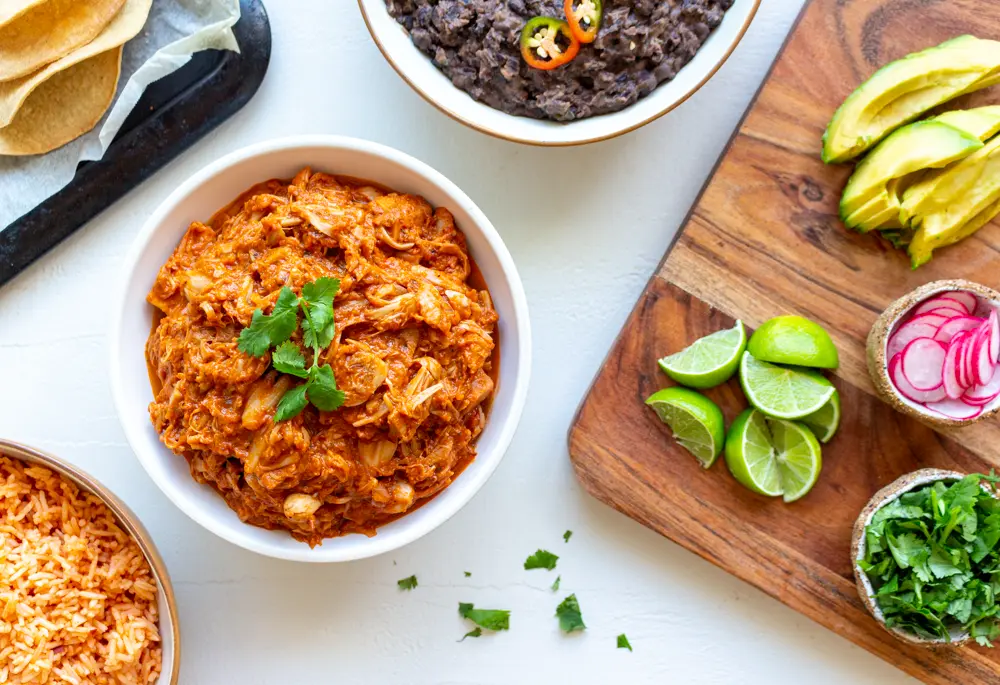 Vegan jackfruit tinga and other Mexican sides like refried black beans and Spanish rice
