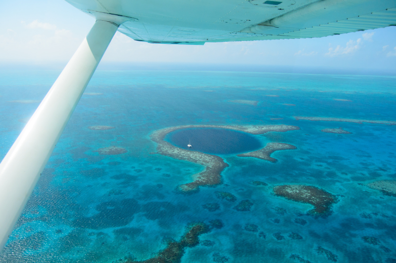 helicopter view of the Great Blue Hole and barrier reef in Belize - one of the best things to do in belize