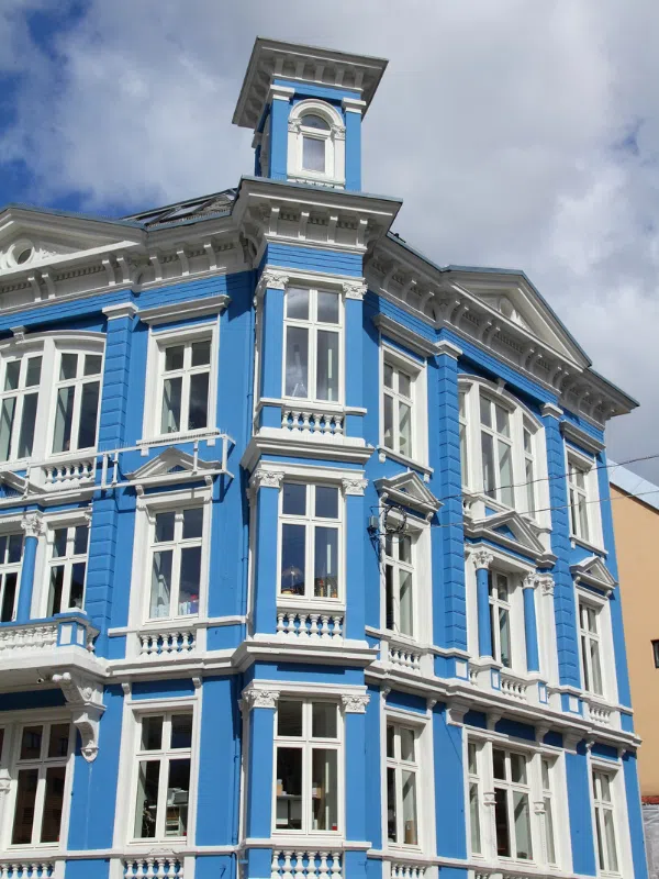 A beautiful old building with blue paint and lovely white trim detailing in Bergen, Norway