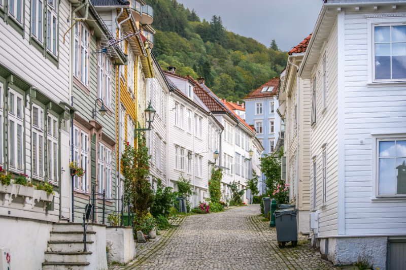 old buildings on a charming street in bergen, norway. one of the best things you can do during your trip is to simply explore on foot. 