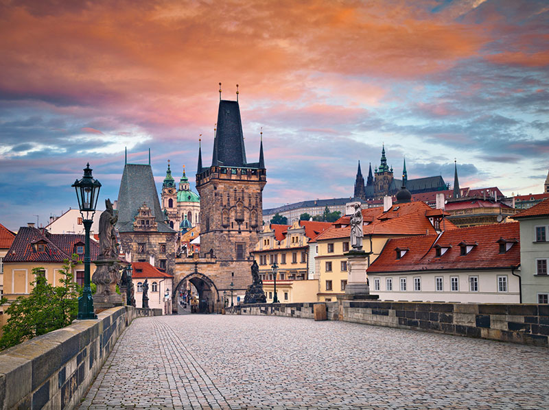 Charles Bridge in Prague and the beautiful architectural buildings at the end of it