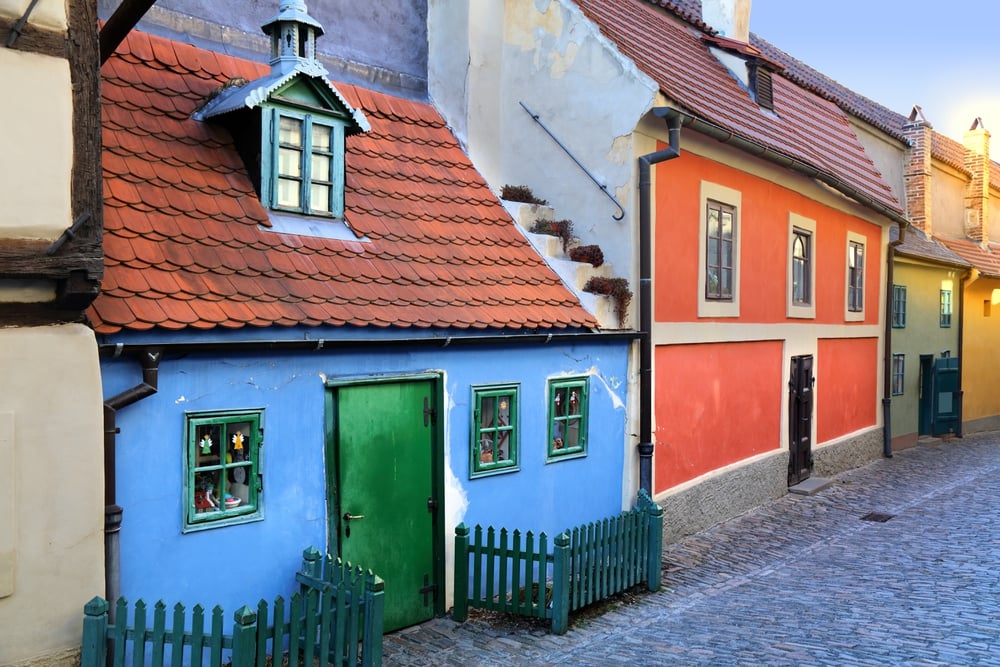 Colorful houses along a cobblestone street in Prague's Golden Lane