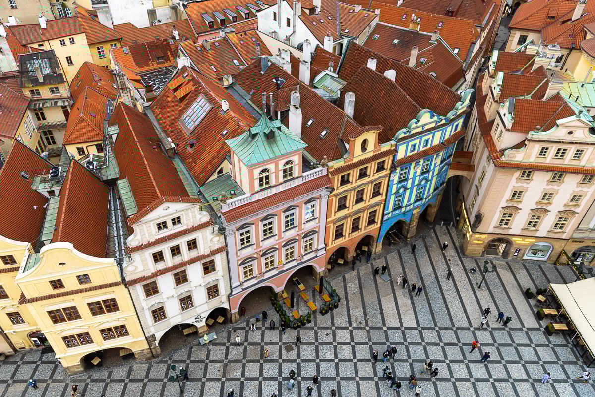 View over Prague from the Old Town Hall Tower showing colorful buildings and a crowd of people on the streets