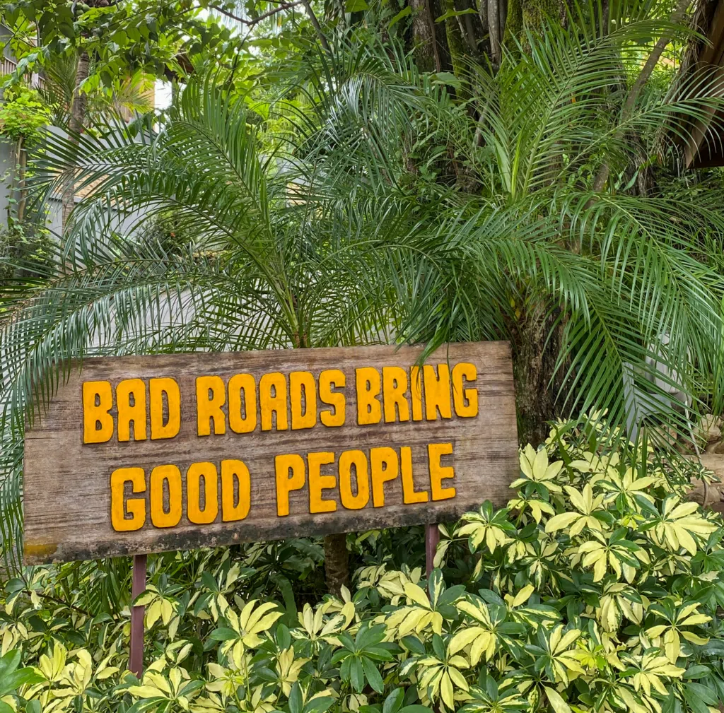 Funny sign "bad roads bring good people" in Nosara, Costa Rica