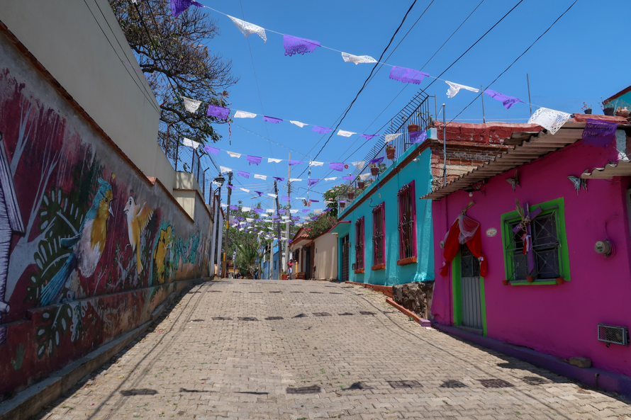 Colorful street art and rainbow-colored colonial buildings in Xochimilco, Oaxaca, Mexico