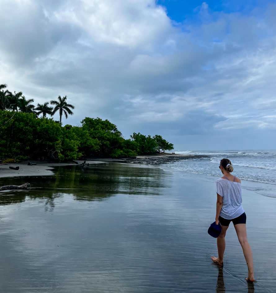 Maddy walking on the beach in Playa Negra, Costa Rica - a beach walk is one of the best things to do