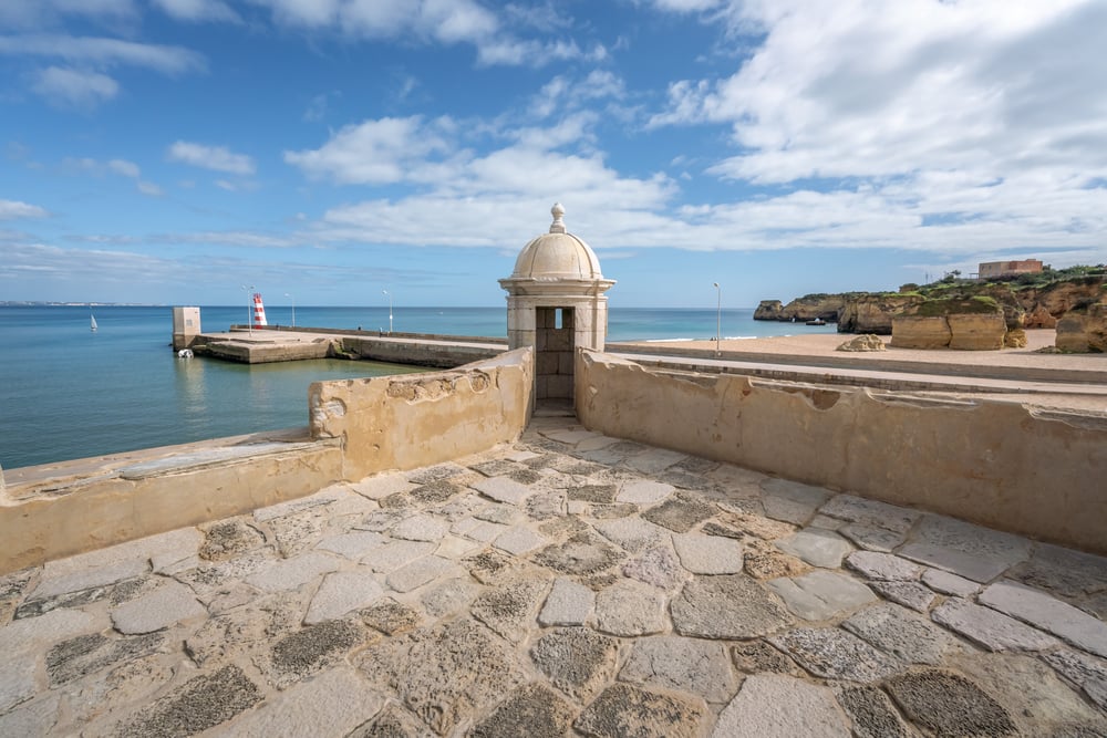 Turret at Fort of Ponta da Bandeira (Forte da Ponta da Bandeira), with the bright blue and calm ocean in the background, Lagos, Algarve, Portugal 