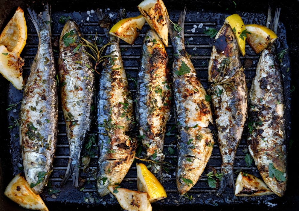 Grilled sardines flavored with herbs and lemons. Eating Algarve cuisine is one of the top things to do in Lagos, Portugal.