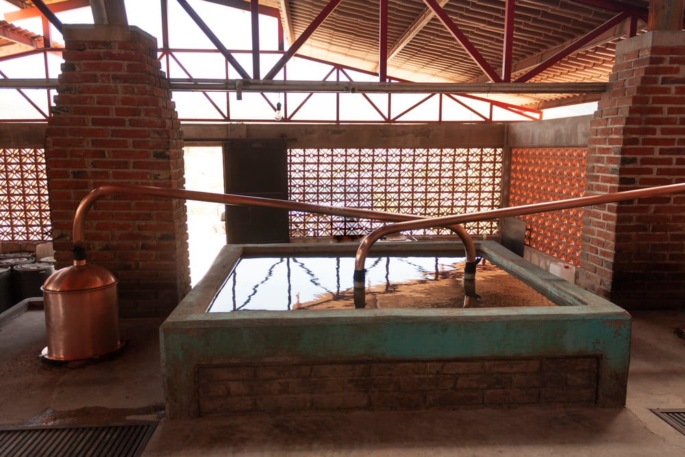 A mezcal distillery with a large bath and copper equipment