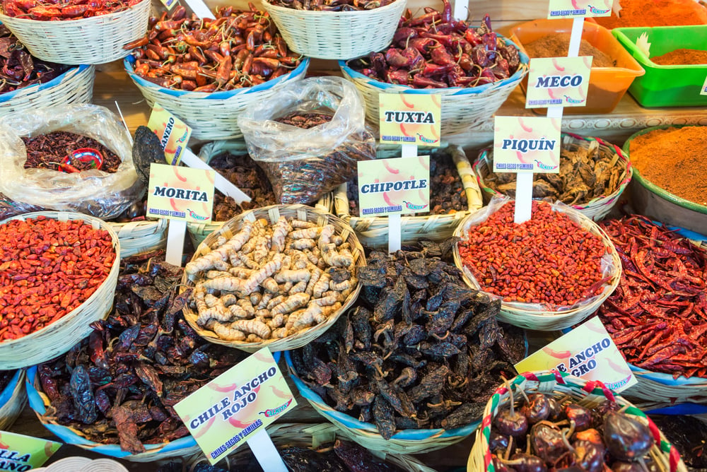 The Benito Juarez market in Oaxaca with spices and chilis being presented in bowls and bags