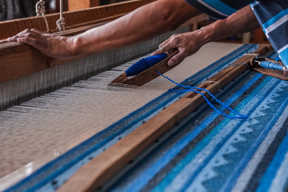 A close-up of the intricate process of making artesanal rugs (tapetes) in Teotitlán, Oaxaca