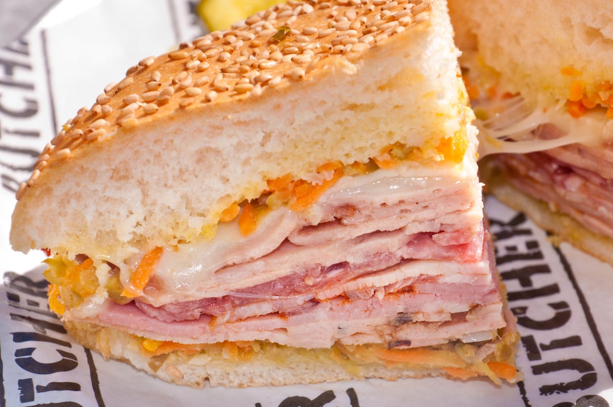 A muffaletta sandwich in New Orleans - experiencing the food is one of the things you must do while on a solo trip.