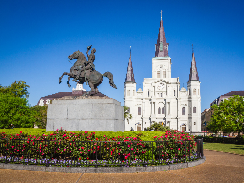 Jackson Square statue and gardens with church in the background