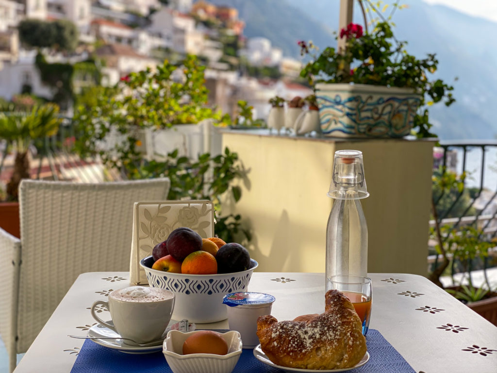 Eating an amazing breakfast in Italy with an ocean view