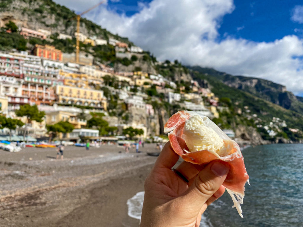 Eating prosciutto and burrata at the beach in Positano