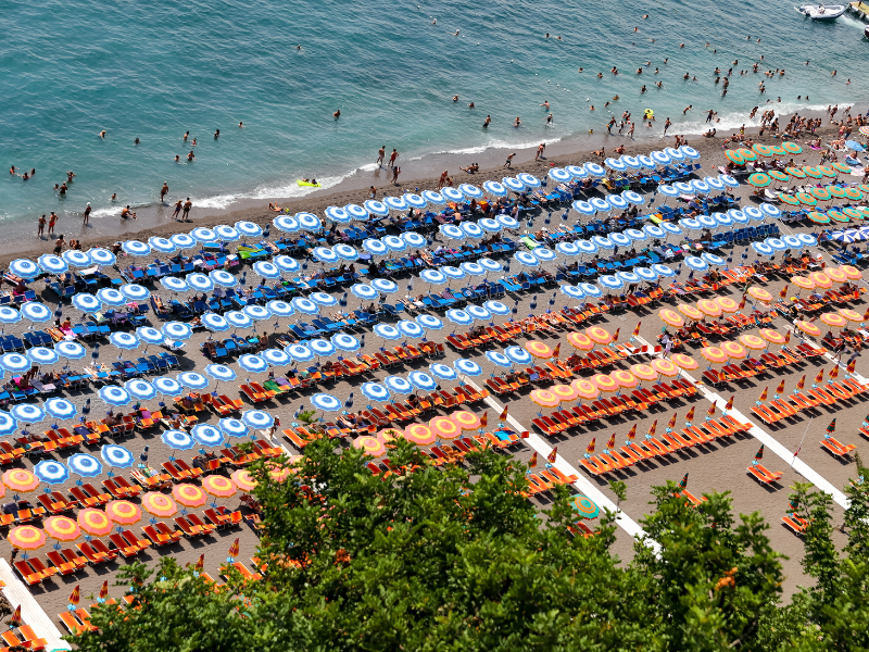 Umbrellas lining the beach in Positano - one of the best Amalfi Coast towns to visit