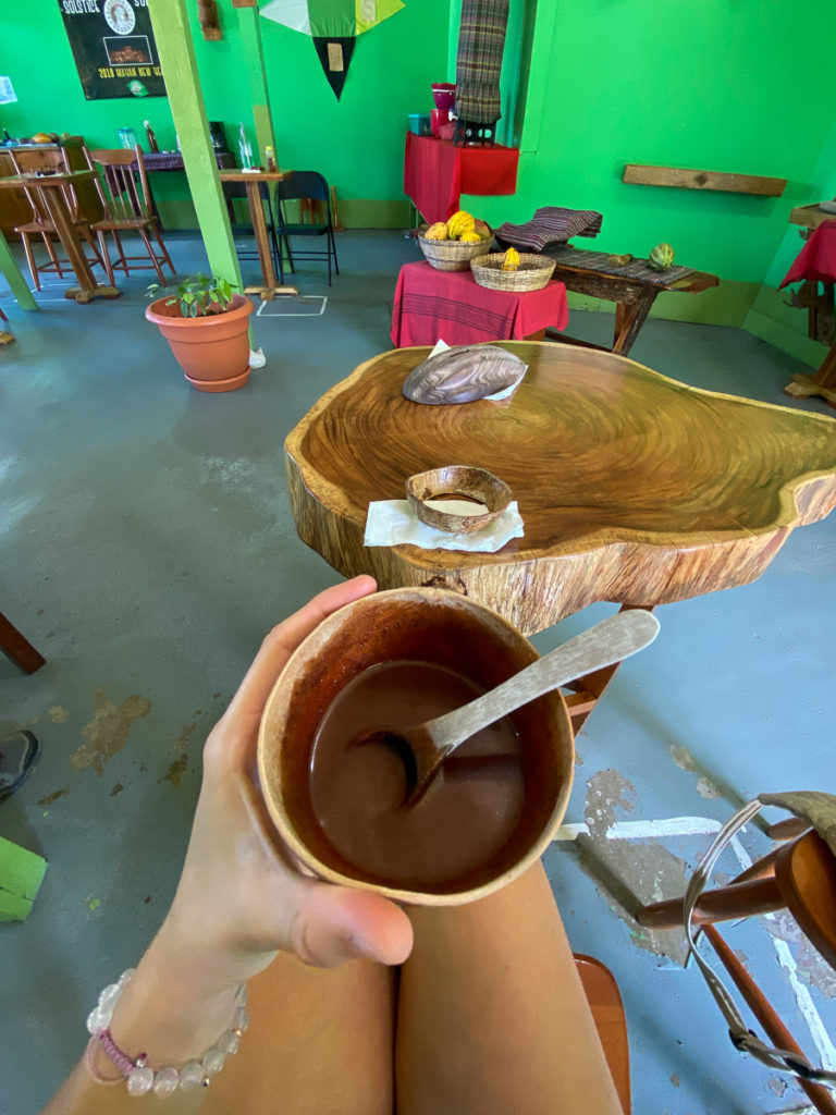 Melanie holding a hot chocolate  - taking a chocolate workshop is one of the best things to do in San Ignacio, Belize!
