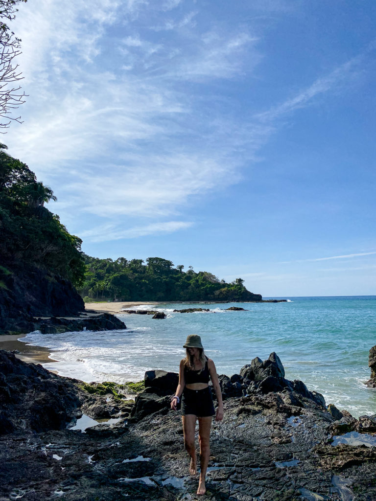 Maddy, a digital nomad in Mexico, walking along the coast of San Pancho