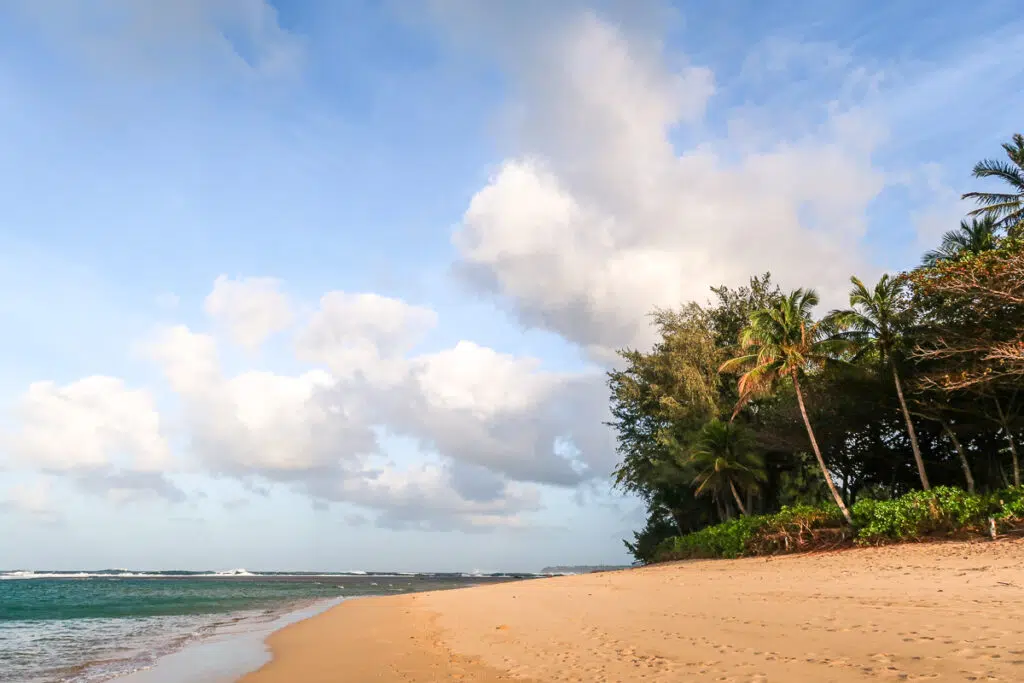 A North Shore beach in Kauai under the blue cloudy skies.